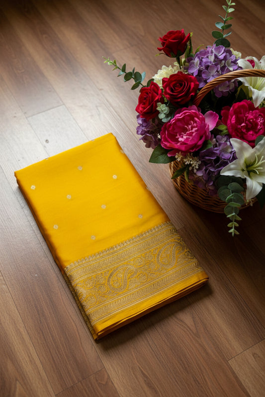 Yellow fabric with intricate patterns on a white background