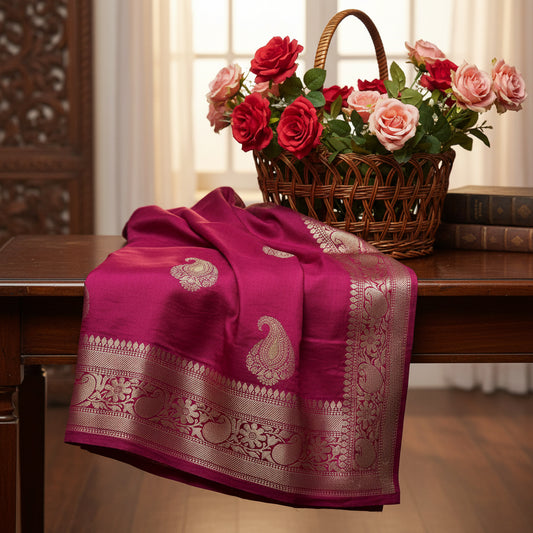 Magenta fabric with gold embroidery on a white background