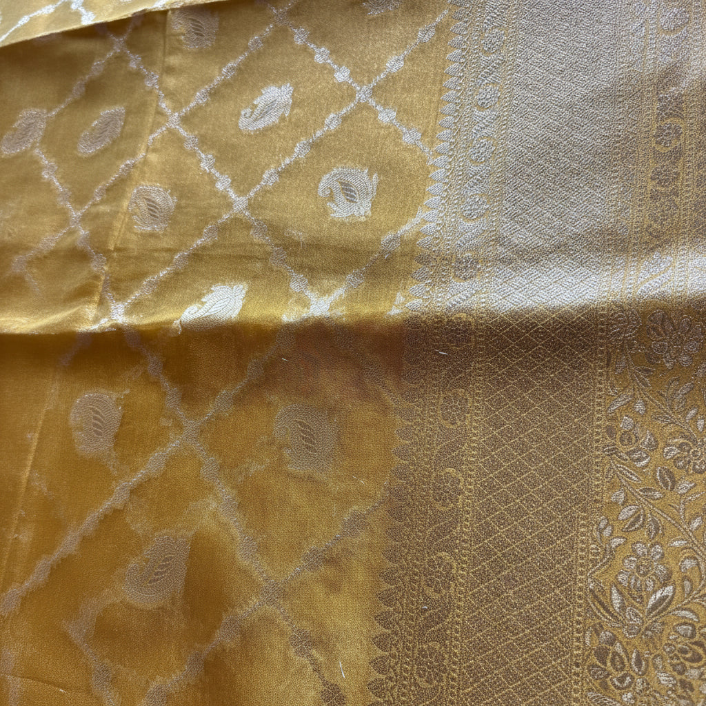 Close-up of a gold fabric with intricate patterns