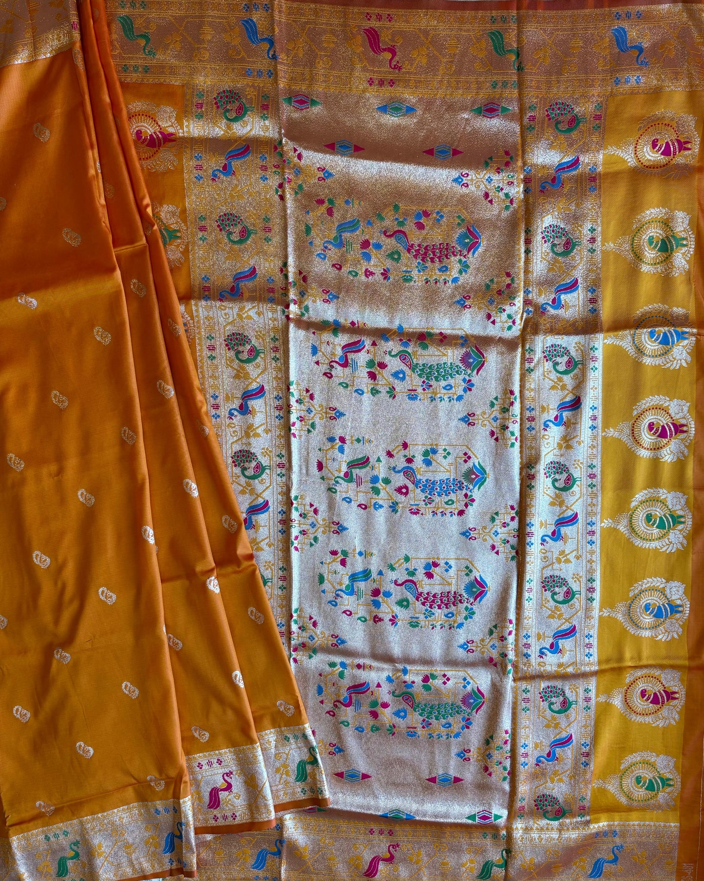 Traditional saree with intricate patterns on a yellow and white background