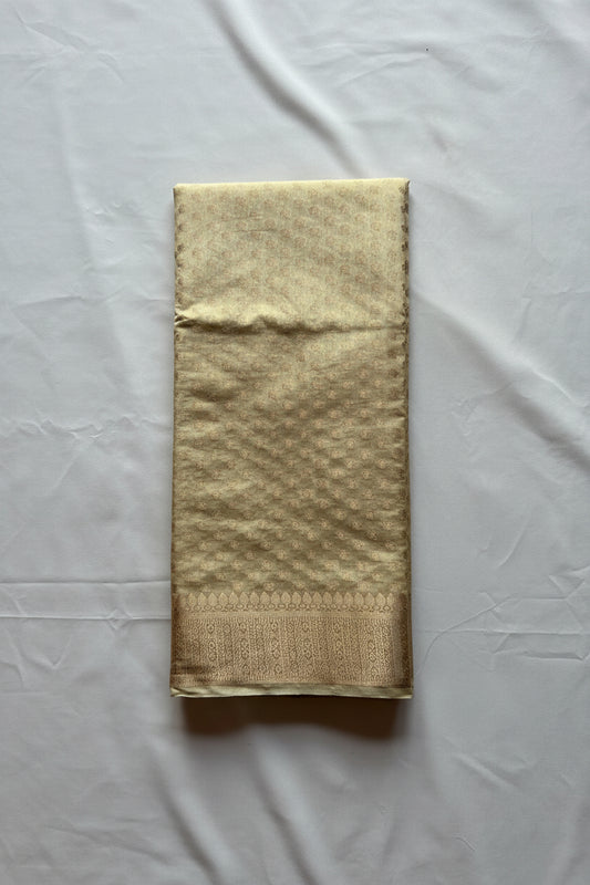 Folded beige fabric with a subtle pattern on a white background